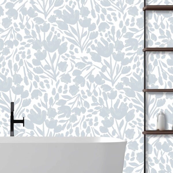 This is a zoomed-in delicate blue floral wallpaper in a serene bathroom setting with a freestanding white tub and wooden shelving