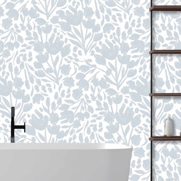 This is a zoomed-in delicate blue floral wallpaper in a serene bathroom setting with a freestanding white tub and wooden shelving