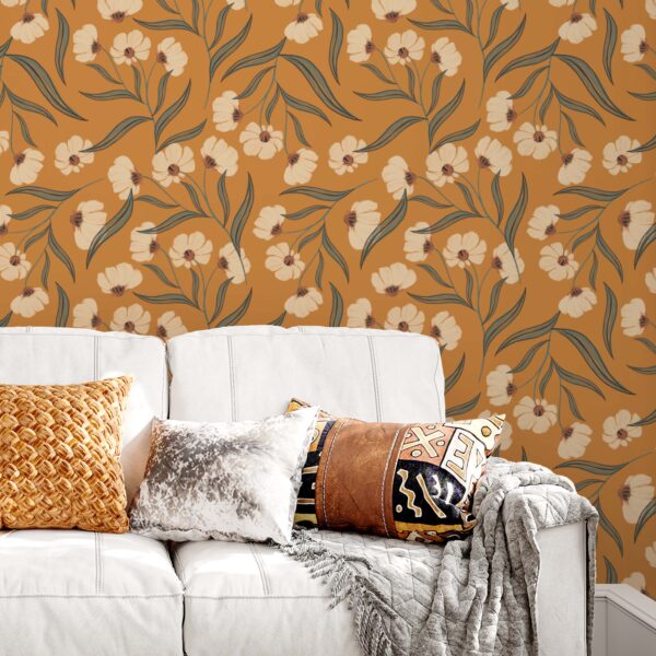 A zoomed-in Boho terracotta floral wallpaper with stylized white blossoms and sage green leaves behind a modern white sofa and layered cushions