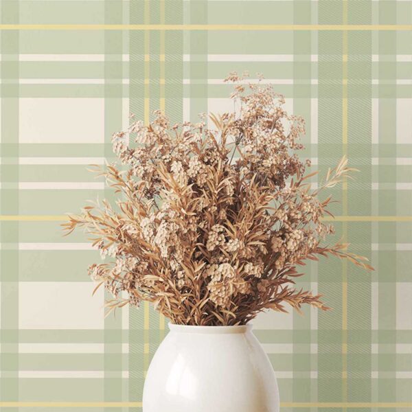 A zoomed-in soft green plaid pattern wallpaper styled in a cozy interior scene