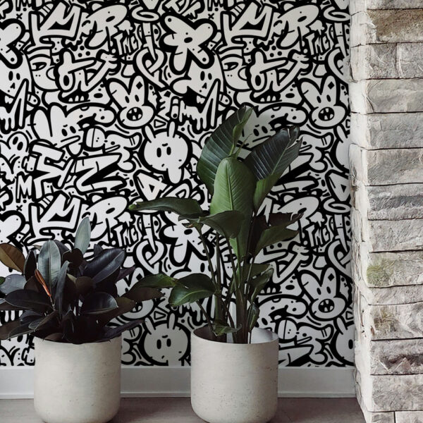 Monochrome zoomed-in graffiti wallpaper with quirky cartoon characters and letters styled in a bold black and white mural pattern