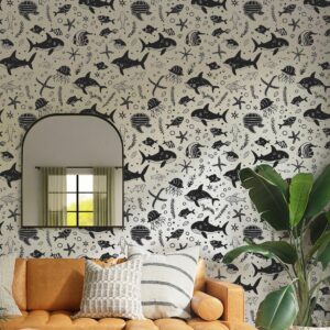 A zoomed-in view of whimsical marine life illustrations featuring sharks, turtles, jellyfish, and fish in a black-and-white pattern on wallpaper.