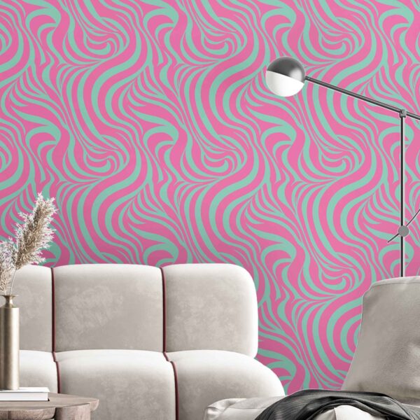 A stick wallpaper in pink and mint wavy abstract lines behind a cream velvet sectional in a modern living room