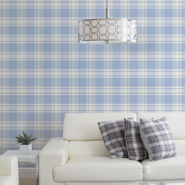 Dusty blue plaid wallpaper in a contemporary living room with cream leather sofas, geometric cushions, and modern drum pendant light.