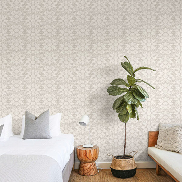 Soft beige variation of June Roses Wallpaper shown in a warm, neutral bedroom with blush accents and modern furnishings.