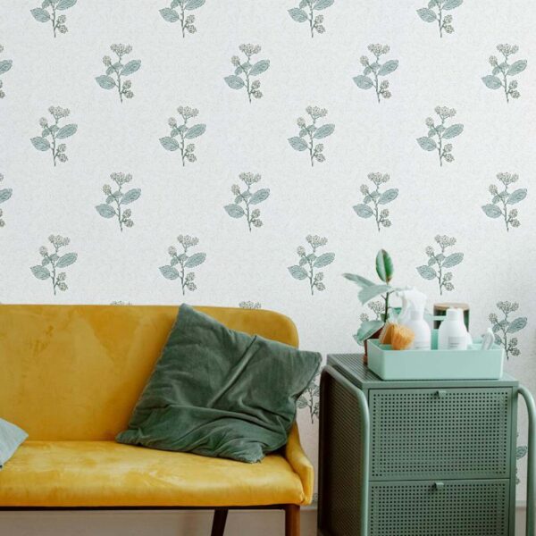 A zoomed-in soft botanical sprigs in vintage green on white wallpaper in a calm living room setting