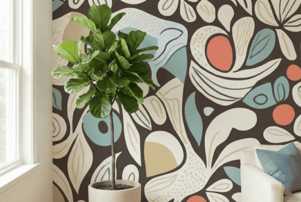 A zoomed-in of abstract botanical mural with curved leaves and retro color accents styled beside a potted fiddle leaf fig.
