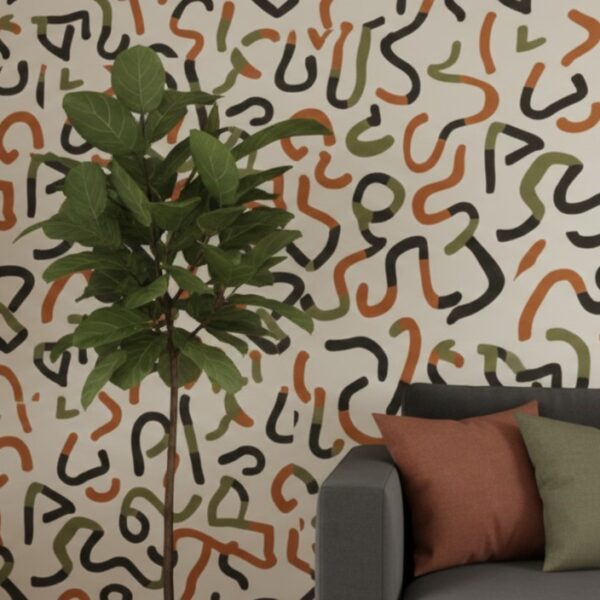 A zoomed-in of an abstract squiggle wallpaper with organic black, green, and terracotta lines paired with neutral seating and indoor plants.