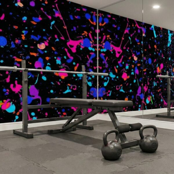 A zoomed-in of a modern fitness room, displaying bold neon splashes on black behind weight benches and kettlebells.