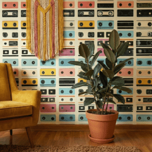 A zoomed-in of a reading corner with retro mixtape wallpaper, highlighting stacked cassette illustrations in soft teal, pink, yellow, and black tones.