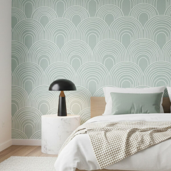 A zoomed-in of sage green arches wallpaper featuring repeating curved line motifs in soft green and white.