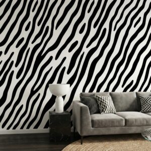 Zebra wave black and white mural in a contemporary living room with lounge chair and natural rug.