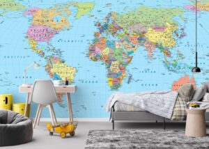 World map wallpaper mural in a kids bedroom with desk and bed
