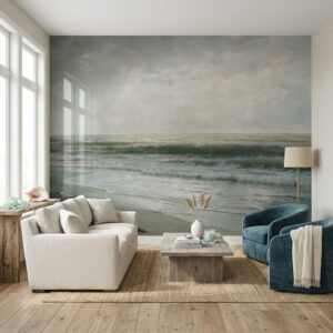 Beach at Sunrise mural with soft ocean waves and cloudy sky behind a neutral living room with sofa and armchair.