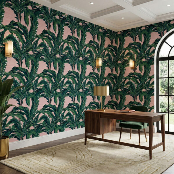 Blush tropical banana leaf wallpaper styled in a home office with dark wood desk, green chair, and arched window.