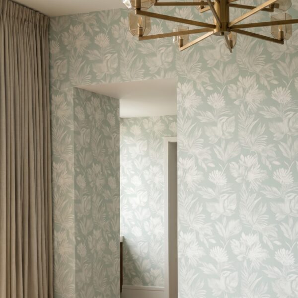A zoomed-in of a modern hallway with subtle leafy pattern in calming green tones.