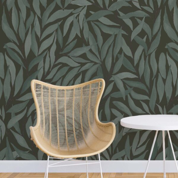 Great Willow wallpaper in blue brown behind a wicker chair and side table with layered leafy pattern