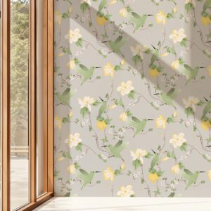 Garden Sage chinoiserie wallpaper featuring birds and blooming branches with natural light casting shadows across the wall
