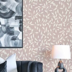 Oxford Court Ivy wallpaper in Petal Clay styled with a blush pink vine pattern behind a dark accent chair and modern artwork