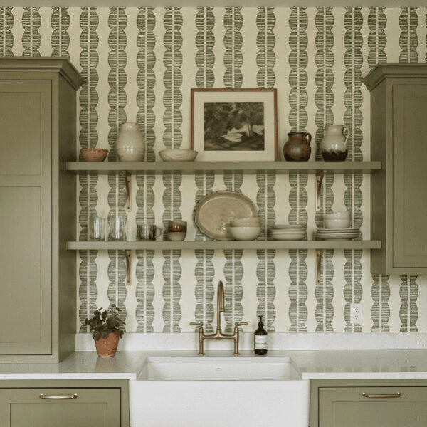 A zoomed-in of Sage Totem wallpaper highlighting textured olive geometric stripes and organic stacked motifs