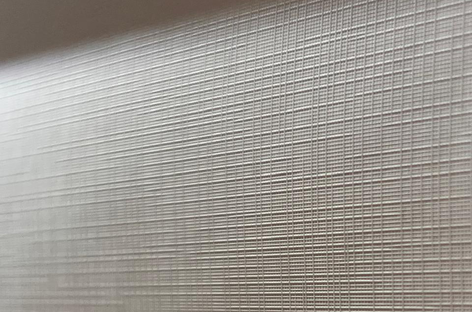A close up view of the Canvas Texture Peel and Stick wallpaper material