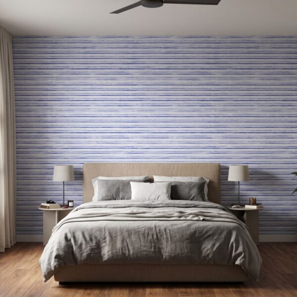 Indigo Gouache Stripes Wallpaper shown in a bedroom