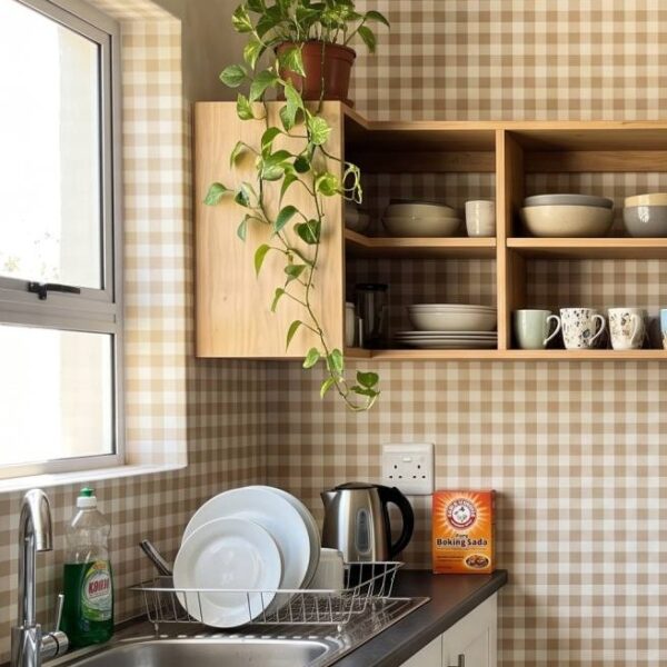 Holly Gingham Ochre wallpaper close-up on a wall